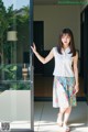 A woman standing in front of a glass door.